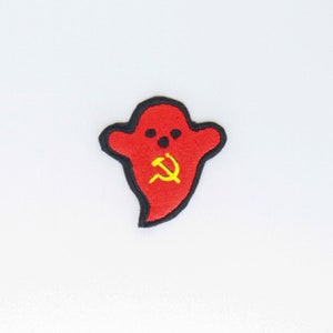 May include: Red ghost with a black outline and a yellow hammer and sickle inside.