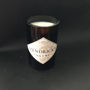 May include: A black glass candle holder with a white label that reads "Hendrick's Gin".