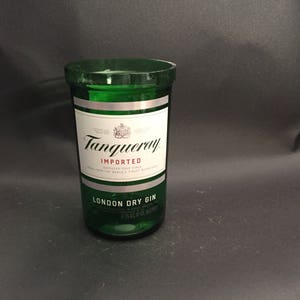 May include: A green glass bottle with a silver label that reads "Tanqueray Imported London Dry Gin".