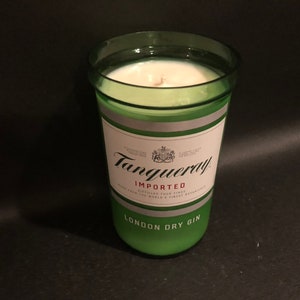 May include: A green glass candle jar with a white label that reads "Tanqueray Imported London Dry Gin".