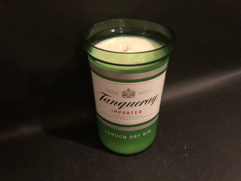 May include: A green glass candle jar with a white label that reads "Tanqueray Imported London Dry Gin".