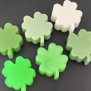 May include: Six four-leaf clover shaped soaps in various shades of green and white.