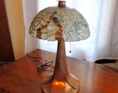Beach Glass Lamp. This one of a kind Beach Glass Lamp is multi-coloured with a stunning copper base, hammered cap and finial.