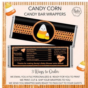 May include: Candy bar wrappers with a black background and orange glitter. The wrappers feature a cartoon candy corn with a smiling face and the text "Candy Corn Candy Bar Wrappers". The wrappers also include a nutrition facts label with a heart icon and the text "Thanks for making Sandy's Baby Shower extra Sweet!"