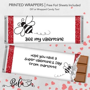 May include: Printable Valentine's Day chocolate bar wrappers featuring a bee illustration and the text "Bee my valentine". The wrappers also include the text "Hope you have a super valentine's day! From. Charlotte".