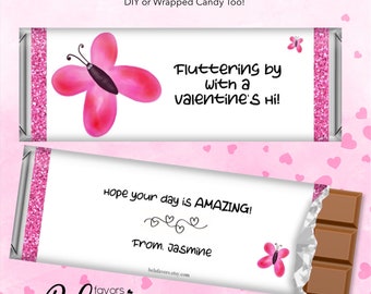 May include: Pink and white chocolate bar wrapper with a butterfly design and the text "Fluttering by with a valentine's Hi!" and "Hope your day is AMAZING! From. Jasmine".