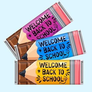 May include: Three rectangular chocolate bars wrapped in paper designed to look like pencils. Each wrapper features a pink, blue, or yellow pencil body with a black tip and eraser, printed with the black text WELCOME BACK TO SCHOOL.