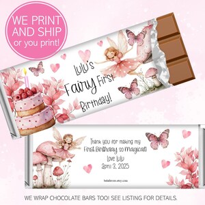 May include: A chocolate bar wrapped in a custom label with a fairy theme. The label features a pink cake, butterflies, and the text "Lulu's Fairy First Birthday!" and "Thank you for making my First Birthday so magical! Love Lulu April 3, 2025."