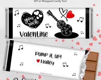 May include: Two printable chocolate bar wrappers with a Valentine's Day theme. The top wrapper features a black and white guitar with a heart and the text "you rock Valentine". The bottom wrapper features a black and white music note and the text "Pump it UP! Hailey".
