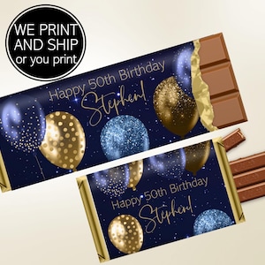 May include: Chocolate bar with a navy blue wrapper featuring gold and blue balloons, and the text "Happy 50th Birthday Stephen!". The bar is partially unwrapped, revealing the chocolate. The text "WE PRINT AND SHIP or you print" is in a circle.