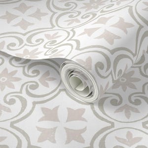 May include: A roll of wallpaper with a repeating pattern of floral and geometric shapes in light grey and pale pink on a white background. The design includes scrolling lines and four-pointed star motifs.