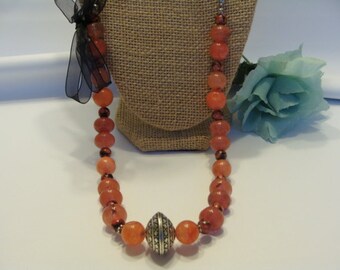 On SALE  15" Peach Passion Glass bead necklace with silver chain and a Black Bow accent