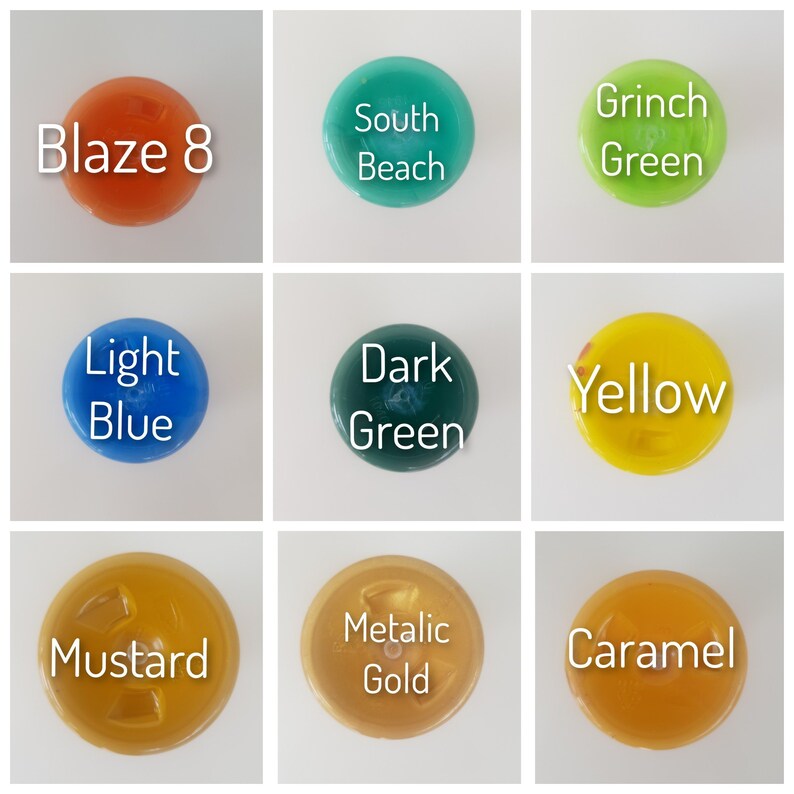 May include: Nine different colored round bottle caps with text labels. The colors are orange, teal, green, blue, dark green, yellow, mustard yellow, gold, and caramel.