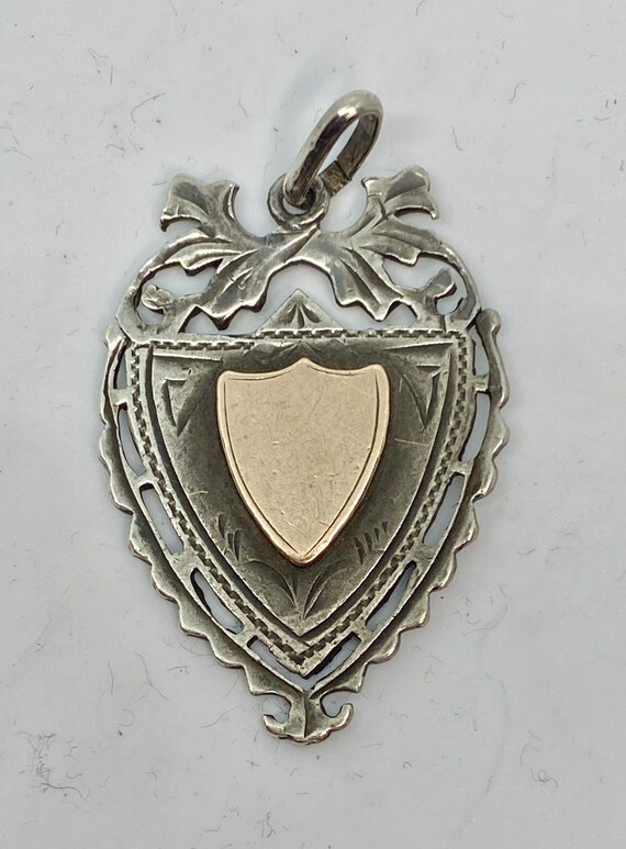 Antique 1900 sterling and gold shield charm from E