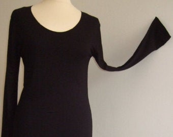 May include: A long-sleeved black dress with a scoop neck and a slightly flared hem.