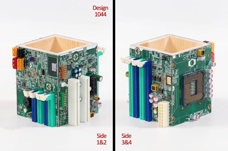 Puede incluir: Un contenedor cuadrado de madera con los lados cubiertos por placas de circuito impreso verdes que presentan varios componentes electr&oacute;nicos, incluyendo ranuras RAM azules y blancas, un z&oacute;calo de CPU y conectores. El texto Design 1044 es visible.