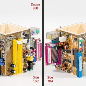 Peut inclure: Un porte-stylo carr&eacute; fabriqu&eacute; &agrave; partir de panneaux de cartes m&egrave;res d'ordinateur recycl&eacute;s. L'ext&eacute;rieur pr&eacute;sente des circuits imprim&eacute;s bruns avec des fentes jaunes, blanches et noires, des condensateurs et divers ports. Le texte indique Design 988.