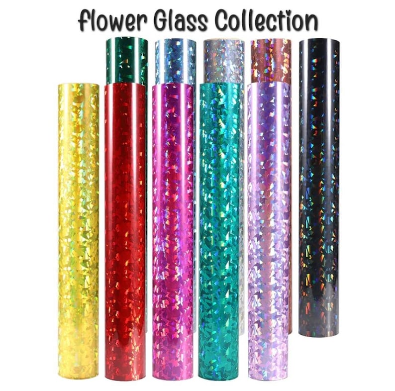 May include: A collection of eight rolls of iridescent vinyl with a flower glass pattern. The rolls are in various colors, including yellow, red, pink, green, purple, and black.