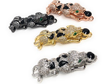 May include: Four panther-shaped charms with black enamel, green gem eyes, and clear crystal accents. The charms are in different metal finishes: black, gold, silver, and rose gold.