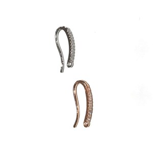 May include: Two jewelry clasps, one silver and one rose gold, with clear crystal accents.