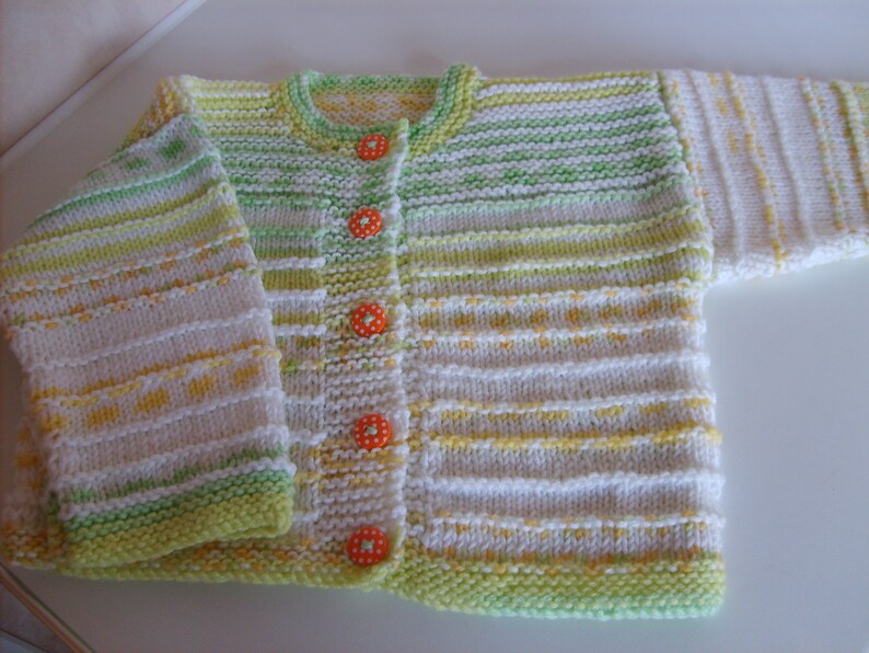 Beautiful citrus Baby Cardigan with striking orange polka dot buttons.