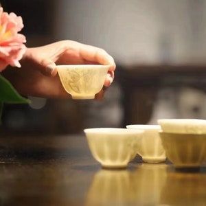 A Set of Five White Porcelain Plum Flower Chinese Tea Cups