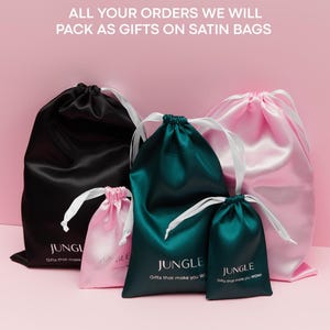 May include: A collection of satin gift bags in black, pink, and teal, each with white drawstrings. The bags are printed with the word "JUNGLE" and the phrases "Gifts that make you WOW!" and "Gifts that make you W". The text "ALL YOUR ORDERS WE WILL PACK AS GIFTS ON SATIN BAGS" is also visible.