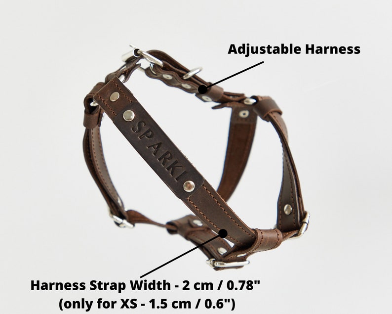 May include: A brown leather adjustable dog harness with silver hardware. The harness is embossed with the name "SPARKI". The harness strap width is 2 cm (0.78 inches), and 1.5 cm (0.6 inches) for XS.