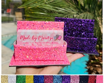 May include: Pink and purple glitter card holders with a black base. The card holders are made by Maritza and are used for glitter name tags, sparkle badge holders, and bling picture frames.