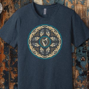 a t - shirt with a picture of a shield on it