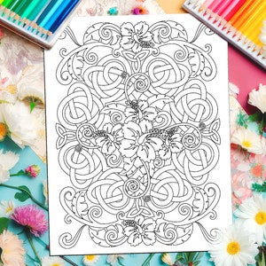 a coloring book surrounded by flowers and a cup of coffee