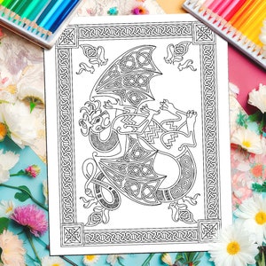 May include: A black and white coloring page featuring a Celtic knot dragon design. The dragon is curled up with its wings spread out. The design is surrounded by a border of Celtic knots.