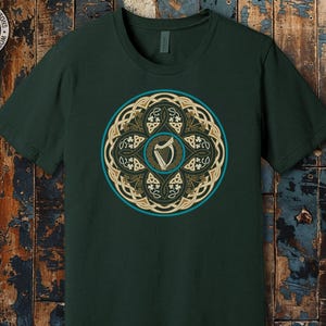 a green t - shirt with a gold and green design on it