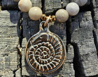 Snakestone on fossilized coral beaded necklace - bronze or copper pendant