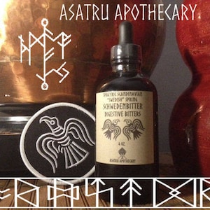 May include: A brown glass bottle with a black label that reads "ASATRU APOTHECARY" and "Swedish Spring KHWEDENBITTER Digestive Bitters". The bottle is sitting on a wooden surface with a black and white embroidered patch of a raven.