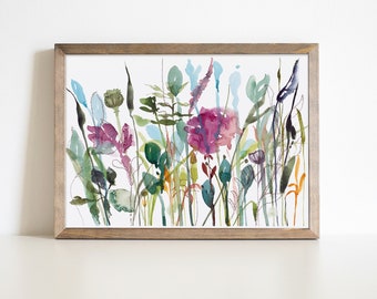 May include: Watercolor painting of a wildflower meadow in a wooden frame. The artwork features a variety of colorful flowers and foliage in shades of purple, green, blue, and orange. The painting is on white paper.