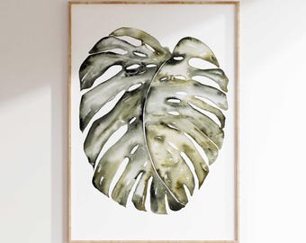 May include: A watercolor painting of a large, green monstera leaf with a white background. The leaf is depicted in a realistic style with detailed veins and textures.