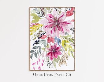 May include: Watercolor painting of a floral bouquet with pink, red, blue, green, and yellow flowers. The painting is framed in a brown wood frame and has the text "Once Upon Paper Co" at the bottom.