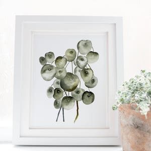 May include: A watercolor painting of a string of green and brown round leaves, framed in a white frame. The painting is titled "Once Upon Paper Co."