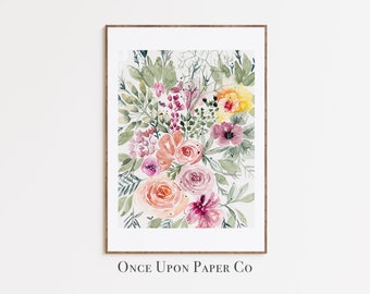 May include: Watercolor floral print in a wooden frame. The artwork features a bouquet of flowers in shades of pink, peach, yellow, and purple, with green foliage. The text "Once Upon Paper Co" is at the bottom.