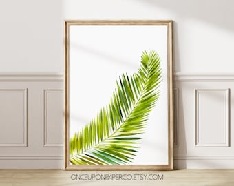 May include: A watercolor painting of a single green palm leaf in a wooden frame. The leaf is depicted in a light green color with a hint of blue. The background is white. The text "ONCEUPONPAPERCO.ETSY.COM" is at the bottom of the image.