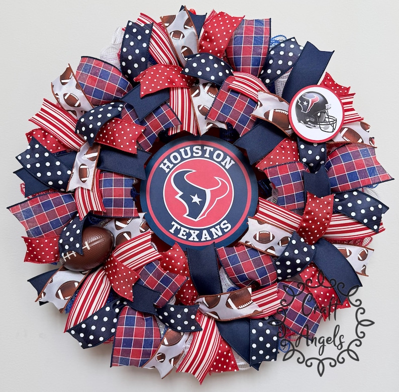 May include: A decorative wreath featuring the Houston Texans logo in the centre and a smaller team helmet emblem. The design incorporates ribbons in navy blue, red, and white, with patterns including polka dots, plaid, stripes, and football graphics.