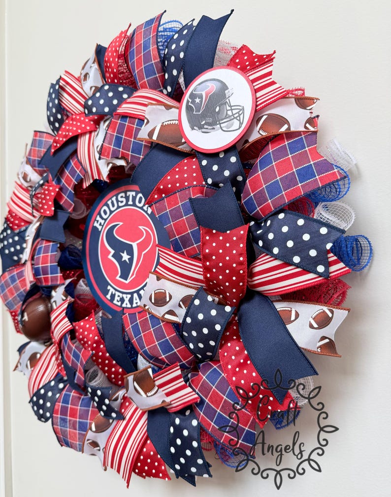May include: A decorative wreath featuring the Houston Texans logo and a football helmet graphic. The design incorporates red, white, and blue ribbons with polka dot, plaid, and striped patterns, interspersed with mesh and small football motifs.