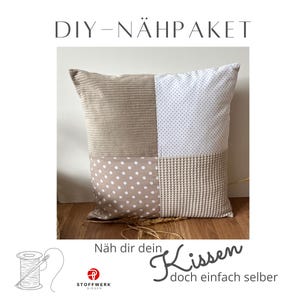 May include: DIY sewing kit for a cushion with a patchwork design. The cushion is made of four different fabrics: beige corduroy, white with small dots, beige with white dots, and beige waffle weave. The kit includes instructions and all the materials needed to make the cushion.