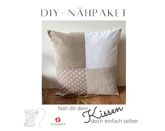 May include: DIY sewing kit for a pillow with a patchwork design. The pillow is made of four different fabrics: beige corduroy, white with small dots, beige with white dots, and beige waffle weave. The kit includes instructions and all the materials needed to make the pillow.