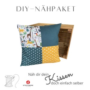 May include: DIY sewing kit for a pillow with a jungle animal print, blue and yellow polka dot fabric, and white stars. The kit includes all the materials needed to make a pillow. The text on the image reads "DIY - NÄHPAKET" and "Näh dir dein Kissen doch einfach selber".