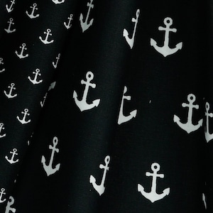 May include: Black fabric with a white anchor pattern. The anchors are repeated throughout the fabric.
