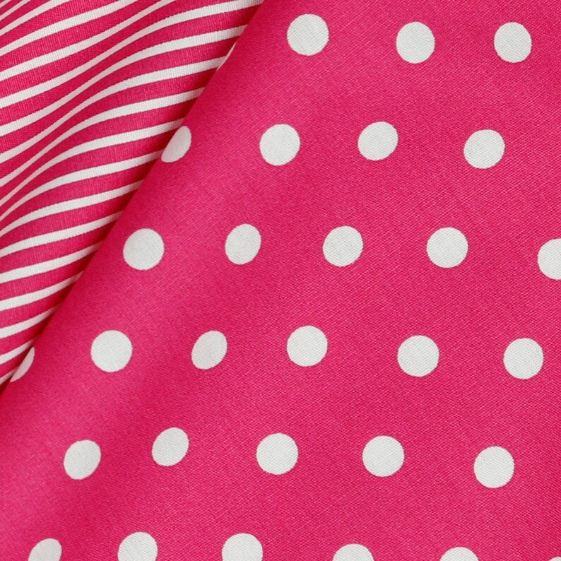 May include: Pink fabric with a white polka dot pattern. The fabric is folded over a white and pink striped fabric.