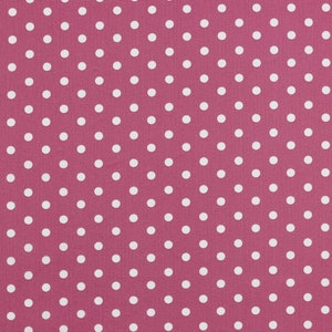 Pode incluir: Um tecido rosa com um padrão de bolinhas brancas.