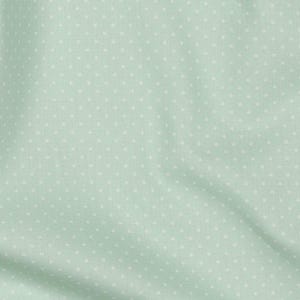 May include: A light green fabric with a white polka dot pattern.